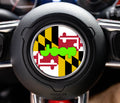 Maryland state flag center-cap overlay with gold-black checker, red-white cross, and lime-green Jeep wordmark